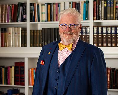 浩博体育app President Jonathan Green posed in front of a bookcase